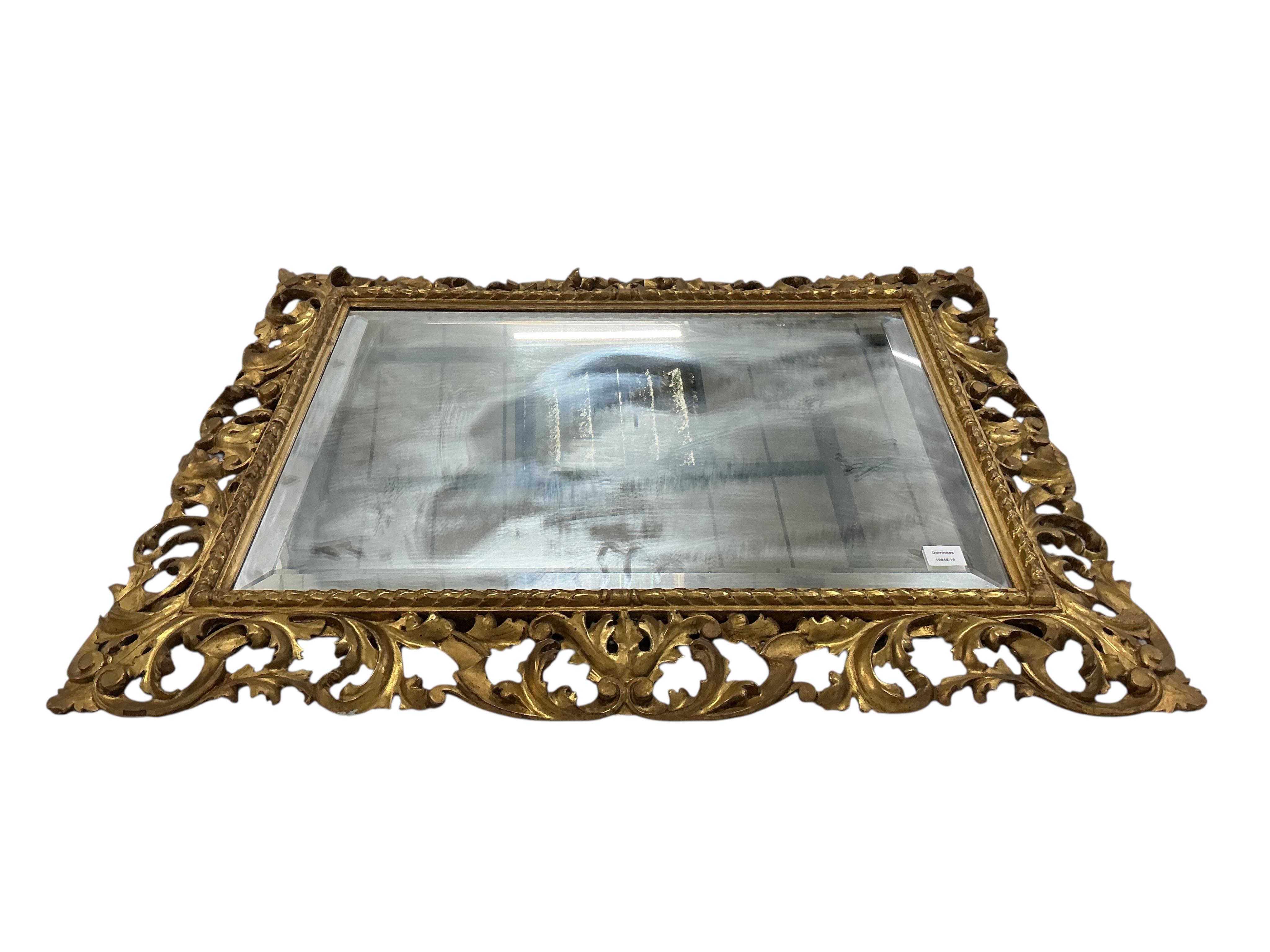 A large 19th century Florentine style carved giltwood rectangular wall mirror, width 112cm, height 89cm